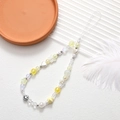 Detail showing handmade beaded phone charm with yellow hearts, stars and butterfly accents - Phone Chain / Smile Mixed Beads Strap (K2942)
