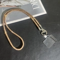 Cordon de téléphone strass champagne avec fermoir cœur argenté sur fond noir élégant - Lanière de cou / Champagne