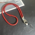 Close-up of luxury red rhinestone phone strap with silver metal lobster clasps - Red