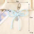 Vista dettagliata del ciondolo cuore e fiocco con dimensioni 12cm per 9cm e peso 9,5g - Stile Fiocco Blu (K3234)
