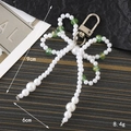Pendentif nœud en perles et perles de verre vertes pour sacs et téléphones - Breloques / Vert