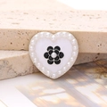 Detailed view of a heart-shaped pearl charm featuring a black camellia for DIY accessory - Enamel Pearl Camellia - Silver Black (D2650)