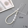 Detailed view of beaded phone strap with white faux pearls and heart charms, 20cm long - 20cm Phone Chain / 3 Heart Pearls