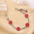Detail of silver chain phone strap with red enamel smiley faces and heart pearl charm - Red (K2950)