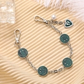 Detail of silver metal phone chain with green enamel smiley faces and heart charm - Dark Green (K2949)