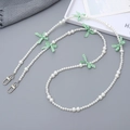 Detail of beaded crossbody phone chain with white faux pearls and green plaid bows - Green Bow (K3451)