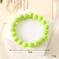 Detailed view of a green tennis ball beaded bracelet with 7cm diameter and 13g weight - Tennis Beaded Bracelet