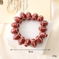 Detail of a brown rugby ball bead bracelet with 8cm diameter and 24g weight on jewelry box - Rugby Beaded Bracelet