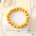Close-up of a yellow acrylic baseball bead bracelet on a gift box for sports fans - Yellow Baseball Beaded Bracelet