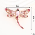Sparkling dragonfly brooch with pink crystals and dimensions 6cm x 4.8cm shown on beige - Pink Dragonfly (D2799)