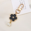 Detail of black enamel flower charm keychain with gold star and faux pearl bead - Faux Shell Flower Style (K3605)