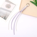 Macro detail of hand-woven leather keychain with purple and white tassels and silver ring - Braided Rope Pendant / White and Purple Contrast (K3939)