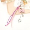 Pink PU leather bow keychain with silver heart charms and braided cords on wooden tray - Pink Bowknot
