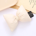 Minimalist cream leather bow accessory with black woven label for bags and shoes - White