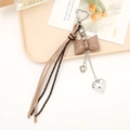 Elegant khaki PU leather bow keychain with heart pendants and vintage pattern tassel - Coffee Bow
