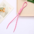 Pink braided rope phone strap with roman knot and white stitching on a neutral tray - Pink