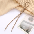 Khaki woven phone strap with white dots and stylish Roman knot detail in a cozy setting - Khaki