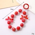 Detail view of 13cm red acrylic rose and bow beaded phone charm with round snap hook - Bird's Nest Bead Pendant Red