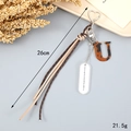 Detail of woven rope keychain with U-shaped tortoise shell charm and silver heart clasp - Letter U (K4292)