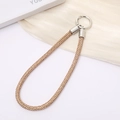 Macro detail of luxury champagne gold rhinestone phone chain with silver spring buckle - Champagne