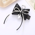 Creative black leather bow keychain with heart metal charm and tassel fringe detail - Cotton Filled Leather Bow Pendant Black (K4118)