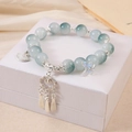 Elegant beaded crystal bracelet with silver fan and butterfly charms on jewelry box - Blue Fan Tassel Bracelet (K4235)