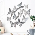 Detailweergave van zilveren uitgeholde 3D-vlinder muurstickers in diverse maten en patronen - Set van vier elk groot middel klein / Zilver