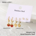 Three pairs of gold stainless steel earrings with strawberry and heart charms on a card - Gold