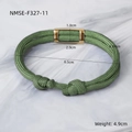 Detail view of a green paracord woven bracelet with a gold rectangular metal clasp - Green