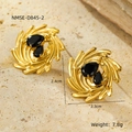 Macro shot of gold textured earrings with black pear-cut stones on a stone surface - Black Water Drop Gemstone Vortex Style (NMSE-D845-2)
