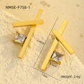 Dettaglio macro di orecchini a croce dorati con zircone quadrato su pietra beige - Stile Incrociato Dorato (NMSE-F758-1)