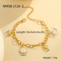 Detail shot of a gold chain bracelet featuring seashell, starfish, and conch charms - Conch Shell Bracelet