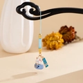 Macro detail of Maneki Neko ceramic charm with lucky tag and blue woven strap - Blue Lucky Cat (K5893)