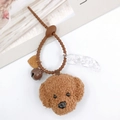 Dettaglio di ciondolo cane Teddy in peluche con cinturino in silicone, campanello e cuore - Marrone Con Campanello