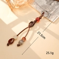 Macro detail of handmade beaded bag charm with PU leather cord and acrylic beads - K5936 Dark Brown (One Pendant Two Lines)