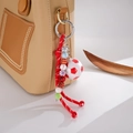 Handmade woven keychain with multi-sports ball beads and a red soccer ball pendant - Red