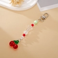 Detailed close-up of acrylic cherry keychain with a transparent star bead and metal clasp - Star Cherry Style
