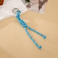 Detail of hand-woven blue nylon paracord keychain with a silver metal spring ring - Sky Blue