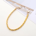 Detail of a braided gold metal chain with yellow leather and dual lobster clasps - Yellow