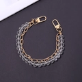 Nahaufnahme der zweilagigen Handykette mit facettierten Perlen und goldener Metallkette - Handkette / Kette Kristall Handkette