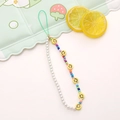 Detailed macro view of colorful smiley face beads and white pearls on a mobile wrist strap - Yellow Smiley & Colorful Glass Beads & Pearls (K930)