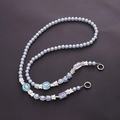 Detail of light blue beaded phone strap with silver bow and heart envelope pendants - K1200 Blue
