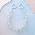 Detalle de la correa de perlas nacaradas con lazos y cierres de anillo blancos - Cadena de Mano con Lazo Blanco Luminoso