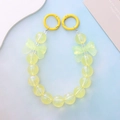 Macro shot of yellow luminous mermaid beads and bow pendants with spring clasps - Luminous Yellow Bowknot Style (K2017)