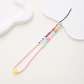 Handmade beaded phone strap with pink clay discs and LOVE letter beads on white tray - Pink Clay LOVE Letter Style (K1069)