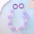 Detalle de cadena de perlas de sirena para móvil con lazos morados y cuentas luminosas - Cadena de Mano con Lazo Degradado Rosa Púrpura Luminoso