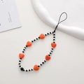 Detail of vibrant orange heart beads and monochrome round beads on a phone wrist strap - K1892 Orange Heart Phone Chain