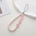 Close-up of pink wooden heart beads on a stylish beaded phone charm wrist strap - K1148 Wooden Heart Phone Chain (Pink)