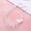 Detail of mermaid beaded phone strap with a white unicorn charm and circular metal rings - Unicorn Hand Chain / White (K2041)
