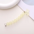 Close-up of matte yellow beaded phone strap with a translucent frosted bear charm - Light Yellow
